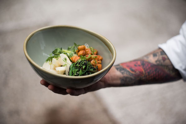 chef arm holding salad